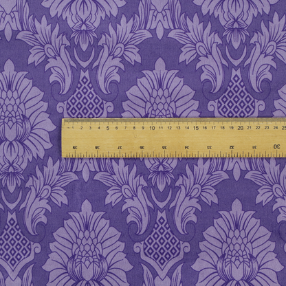 Regal royal purple damask fabric featuring a large-scale, repeating floral and acanthus leaf pattern in a shimmering tonal violet colourway.