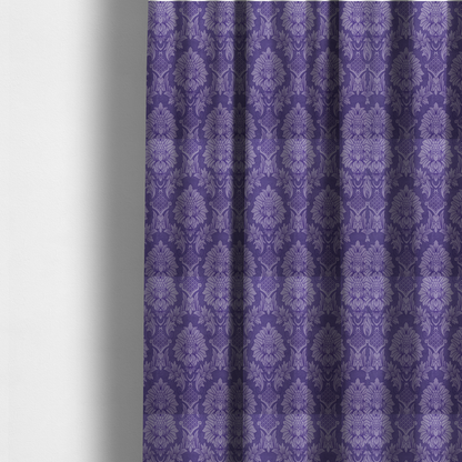 The fabric  used to create these made-to-measure curtains is a regal royal purple damask fabric featuring a large-scale, repeating floral and acanthus leaf pattern in a shimmering tonal violet colourway.