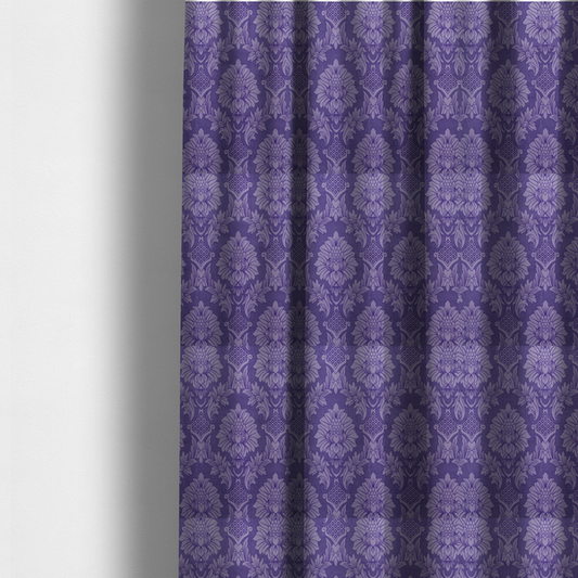 The fabric  used to create these made-to-measure curtains is a regal royal purple damask fabric featuring a large-scale, repeating floral and acanthus leaf pattern in a shimmering tonal violet colourway.