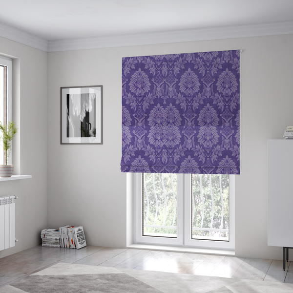 The fabric used to create these Roman blinds is a regal royal purple damask fabric featuring a large-scale, repeating floral and acanthus leaf pattern in a shimmering tonal violet colourway.