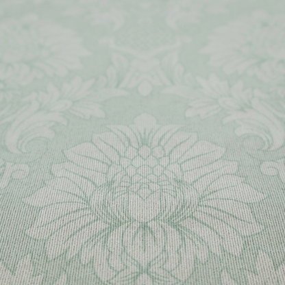 Elegant pale grey damask fabric featuring a large-scale, repeating floral medallion pattern in shimmering silvery-white tones.