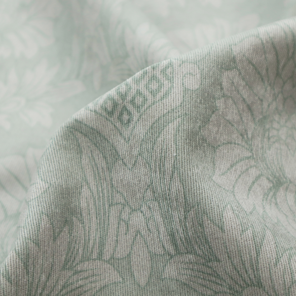 Elegant pale grey damask fabric featuring a large-scale, repeating floral medallion pattern in shimmering silvery-white tones.