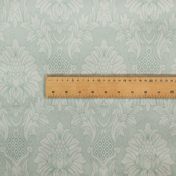 Elegant pale grey damask fabric featuring a large-scale, repeating floral medallion pattern in shimmering silvery-white tones.