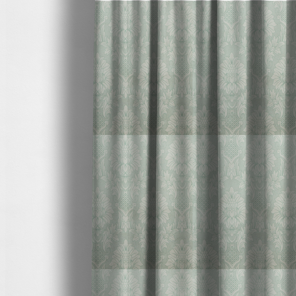 The fabric used to create these made-to-measure curtains is a elegant pale grey damask fabric featuring a large-scale, repeating floral medallion pattern in shimmering silvery-white tones.