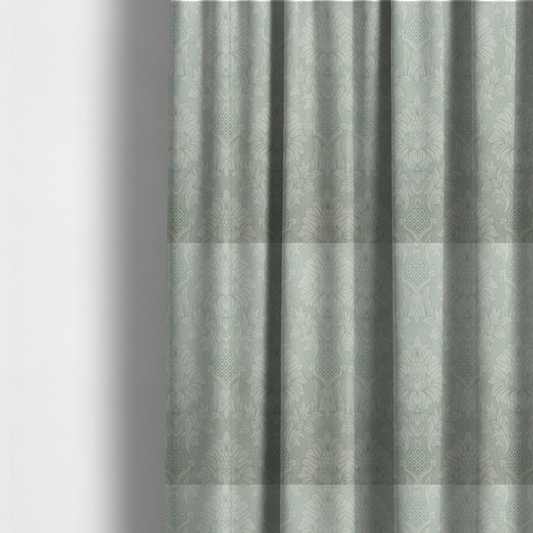 The fabric used to create these made-to-measure curtains is a elegant pale grey damask fabric featuring a large-scale, repeating floral medallion pattern in shimmering silvery-white tones.