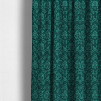 The fabric used to create these made-to-measure curtains is a deep peacock teal damask fabric featuring a large-scale, repeating floral and acanthus leaf pattern in a rich, shimmering tonal colourway.