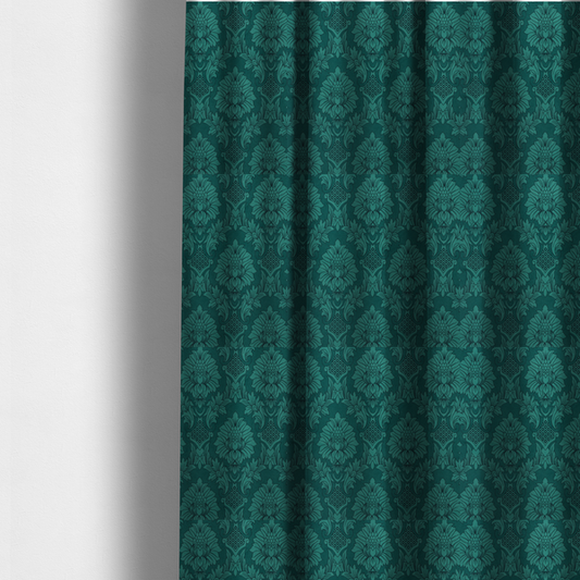 The fabric used to create these made-to-measure curtains is a deep peacock teal damask fabric featuring a large-scale, repeating floral and acanthus leaf pattern in a rich, shimmering tonal colourway.