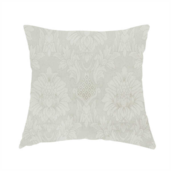 The fabric used to create this handmade cushion is a off-white and silver-grey damask fabric with a large-scale, repeating floral medallion pattern in a subtle, shimmering tonal colourway.