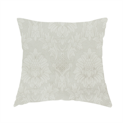 The fabric used to create this handmade cushion is a off-white and silver-grey damask fabric with a large-scale, repeating floral medallion pattern in a subtle, shimmering tonal colourway.