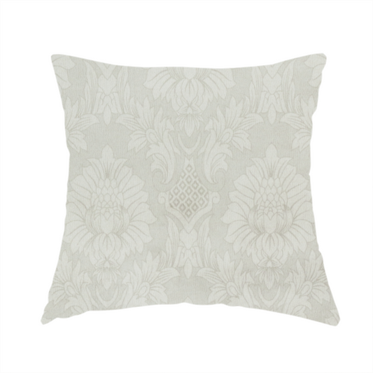 The fabric used to create this handmade cushion is a off-white and silver-grey damask fabric with a large-scale, repeating floral medallion pattern in a subtle, shimmering tonal colourway.