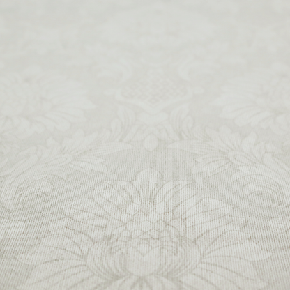 Off-white and silver-grey damask fabric with a large-scale, repeating floral medallion pattern in a subtle, shimmering tonal colourway.