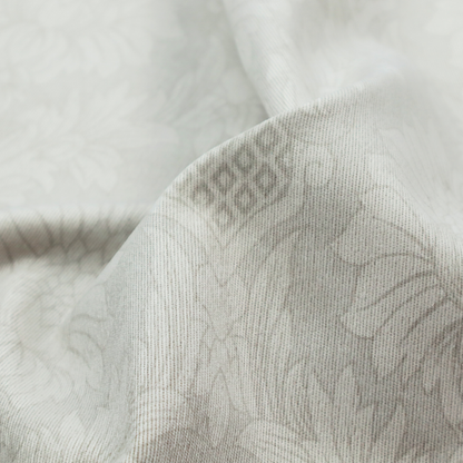 Off-white and silver-grey damask fabric with a large-scale, repeating floral medallion pattern in a subtle, shimmering tonal colourway.