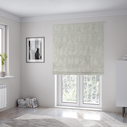 The fabric used to create these Roman blinds is a off-white and silver-grey damask fabric with a large-scale, repeating floral medallion pattern in a subtle, shimmering tonal colourway.