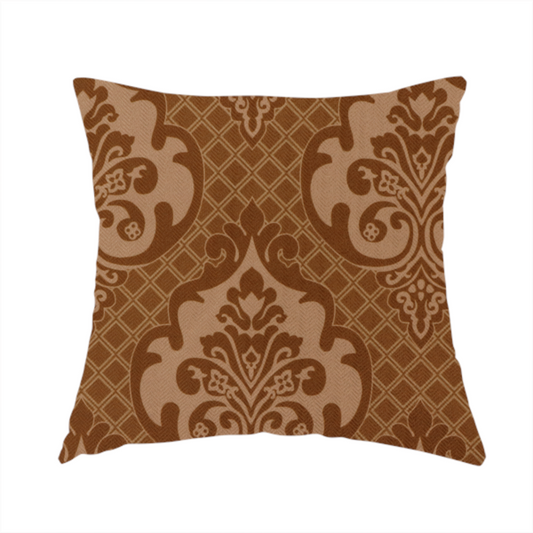 The fabric used to create this handmade cushion is a repeating damask pattern in warm shades of copper, cocoa, and tan. Large, ornate floral medallions featuring stylized acanthus leaves and small blossoms are arranged in an alternating grid.