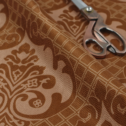 A repeating damask pattern in warm shades of copper, cocoa, and tan. Large, ornate floral medallions featuring stylized acanthus leaves and small blossoms are arranged in an alternating grid.