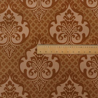 A repeating damask pattern in warm shades of copper, cocoa, and tan. Large, ornate floral medallions featuring stylized acanthus leaves and small blossoms are arranged in an alternating grid.