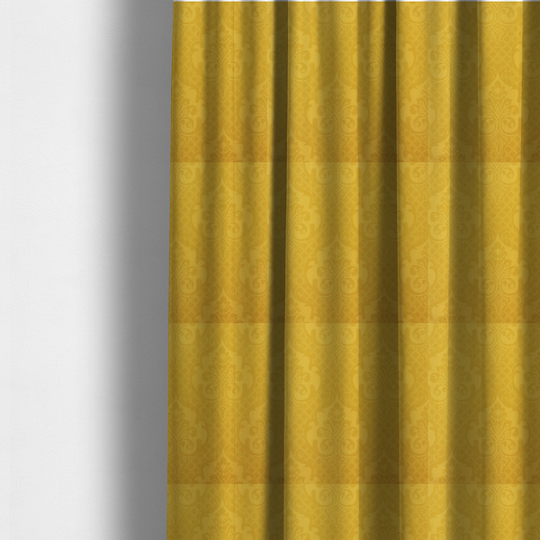 The fabric used to create these made-to-measure curtains is a vibrant yellow damask fabric featuring a tonal, monochrome design. Ornate, stylized floral medallions and acanthus leaves are woven in a slightly lighter shade of yellow, creating a subtle shimmer. The pattern is set against a background of a fine diagonal lattice grid, with a visible woven texture throughout the material.