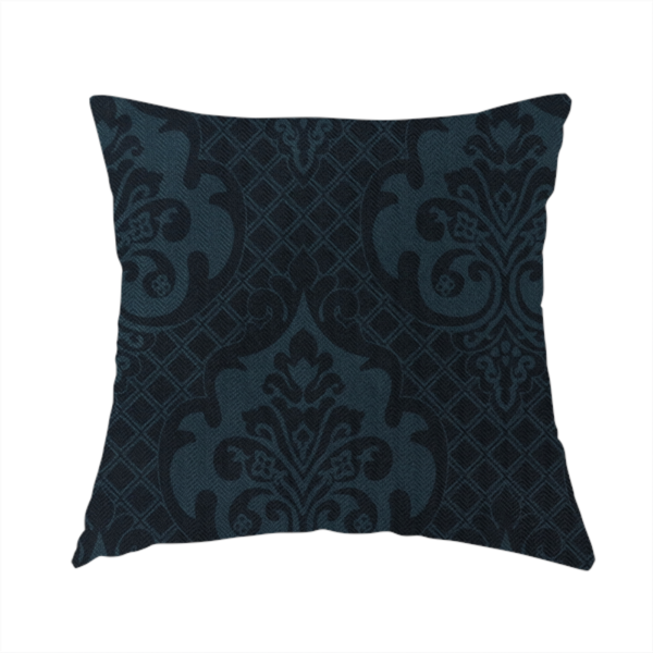 The fabric used to create this handmade cushion is a charcoal damask fabric with a rich, moody aesthetic. The pattern features large, intricate floral medallions and acanthus leaf scrolls in a dark teal hue, set against a slightly darker, nearly black background. A fine diagonal lattice grid fills the spaces between the motifs, and the material displays a clear, woven texture that adds depth to the monochrome design.