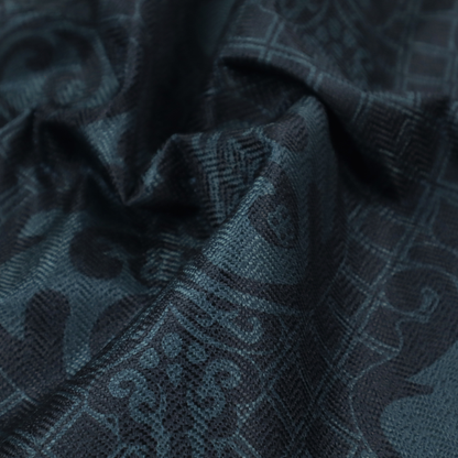 A charcoal damask fabric with a rich, moody aesthetic. The pattern features large, intricate floral medallions and acanthus leaf scrolls in a dark teal hue, set against a slightly darker, nearly black background. A fine diagonal lattice grid fills the spaces between the motifs, and the material displays a clear, woven texture that adds depth to the monochrome design.