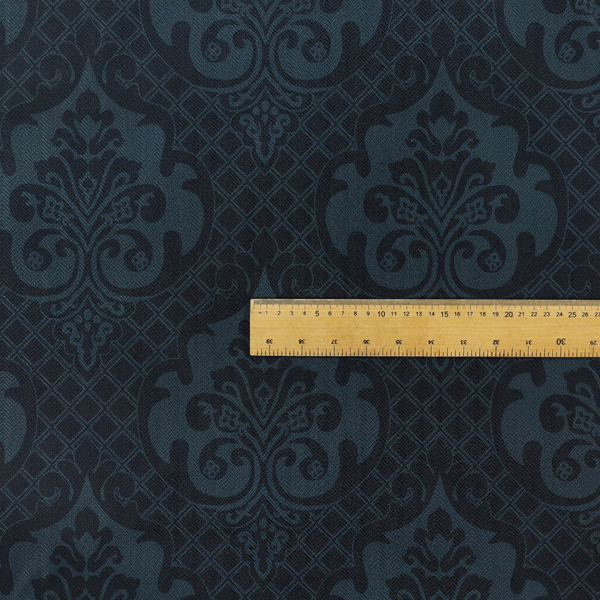 A charcoal damask fabric with a rich, moody aesthetic. The pattern features large, intricate floral medallions and acanthus leaf scrolls in a dark teal hue, set against a slightly darker, nearly black background. A fine diagonal lattice grid fills the spaces between the motifs, and the material displays a clear, woven texture that adds depth to the monochrome design.