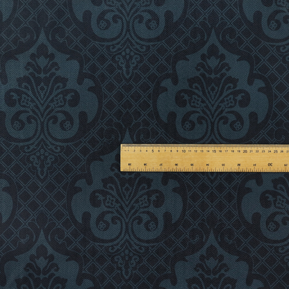 A charcoal damask fabric with a rich, moody aesthetic. The pattern features large, intricate floral medallions and acanthus leaf scrolls in a dark teal hue, set against a slightly darker, nearly black background. A fine diagonal lattice grid fills the spaces between the motifs, and the material displays a clear, woven texture that adds depth to the monochrome design.