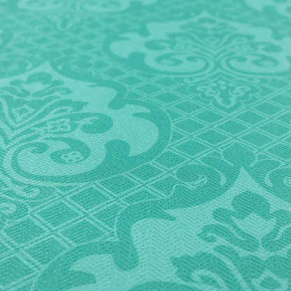 The design features large, ornate floral medallions and scrolling acanthus leaves in a bright turquoise shade, set against a slightly lighter mint green background. A fine diagonal lattice grid fills the background between the motifs, and the material shows a clear woven texture that provides visual depth to the tonal design.