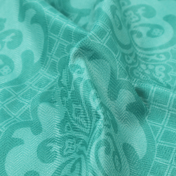 The design features large, ornate floral medallions and scrolling acanthus leaves in a bright turquoise shade, set against a slightly lighter mint green background. A fine diagonal lattice grid fills the background between the motifs, and the material shows a clear woven texture that provides visual depth to the tonal design.