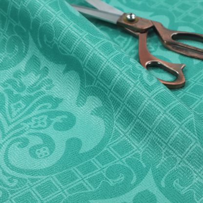 The design features large, ornate floral medallions and scrolling acanthus leaves in a bright turquoise shade, set against a slightly lighter mint green background. A fine diagonal lattice grid fills the background between the motifs, and the material shows a clear woven texture that provides visual depth to the tonal design.