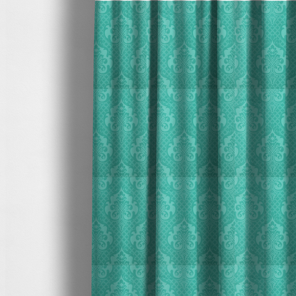 The fabric used to create these made-to-measure curtains has a design that features large, ornate floral medallions and scrolling acanthus leaves in a bright turquoise shade, set against a slightly lighter mint green background. A fine diagonal lattice grid fills the background between the motifs, and the material shows a clear woven texture that provides visual depth to the tonal design.