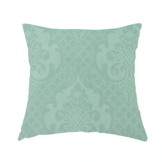 The fabric used to create this handmade cushion has a design that consists of large, ornate floral medallions and scrolling acanthus leaves woven in a shade very close to the background colour, creating a delicate, shimmering effect. A fine diagonal lattice grid fills the background between the motifs, and the material displays a clear woven texture throughout.