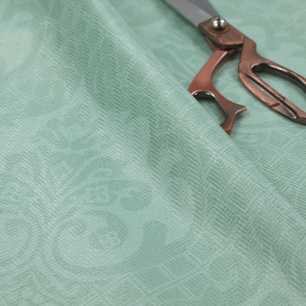 The design consists of large, ornate floral medallions and scrolling acanthus leaves woven in a shade very close to the background colour, creating a delicate, shimmering effect. A fine diagonal lattice grid fills the background between the motifs, and the material displays a clear woven texture throughout.