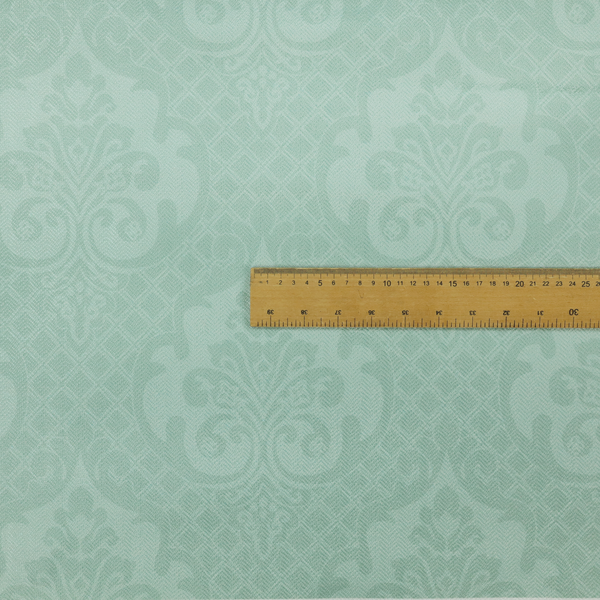 The design consists of large, ornate floral medallions and scrolling acanthus leaves woven in a shade very close to the background colour, creating a delicate, shimmering effect. A fine diagonal lattice grid fills the background between the motifs, and the material displays a clear woven texture throughout.