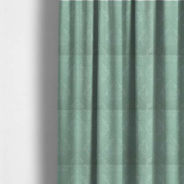 The fabric used to create these made-to-measure curtains has a design that consists of large, ornate floral medallions and scrolling acanthus leaves woven in a shade very close to the background colour, creating a delicate, shimmering effect. A fine diagonal lattice grid fills the background between the motifs, and the material displays a clear woven texture throughout.