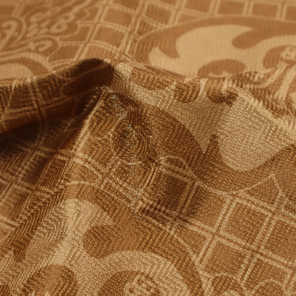 The design features large, ornate floral medallions and scrolling acanthus leaves in a warm tan shade, set against a rich golden-brown background. A fine diagonal lattice grid creates a diamond pattern in the negative space between the motifs, and the material displays a clear woven texture that adds depth and a subtle sheen to the pattern.
