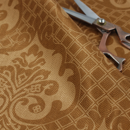The design features large, ornate floral medallions and scrolling acanthus leaves in a warm tan shade, set against a rich golden-brown background. A fine diagonal lattice grid creates a diamond pattern in the negative space between the motifs, and the material displays a clear woven texture that adds depth and a subtle sheen to the pattern.