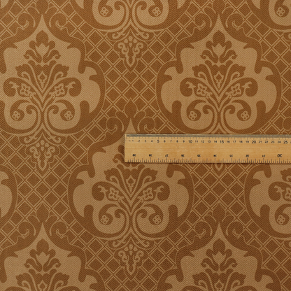 The design features large, ornate floral medallions and scrolling acanthus leaves in a warm tan shade, set against a rich golden-brown background. A fine diagonal lattice grid creates a diamond pattern in the negative space between the motifs, and the material displays a clear woven texture that adds depth and a subtle sheen to the pattern.