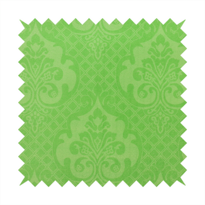 The design features large, ornate floral medallions and scrolling acanthus leaves in a vibrant lime shade, set against a slightly lighter green background. A fine diagonal lattice grid fills the background between the motifs, and the material shows a clear woven texture that provides visual depth to the tonal design.