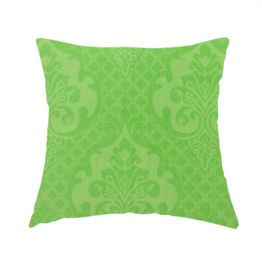 The fabric used to create this handmade cushion has a design that features large, ornate floral medallions and scrolling acanthus leaves in a vibrant lime shade, set against a slightly lighter green background. A fine diagonal lattice grid fills the background between the motifs, and the material shows a clear woven texture that provides visual depth to the tonal design.