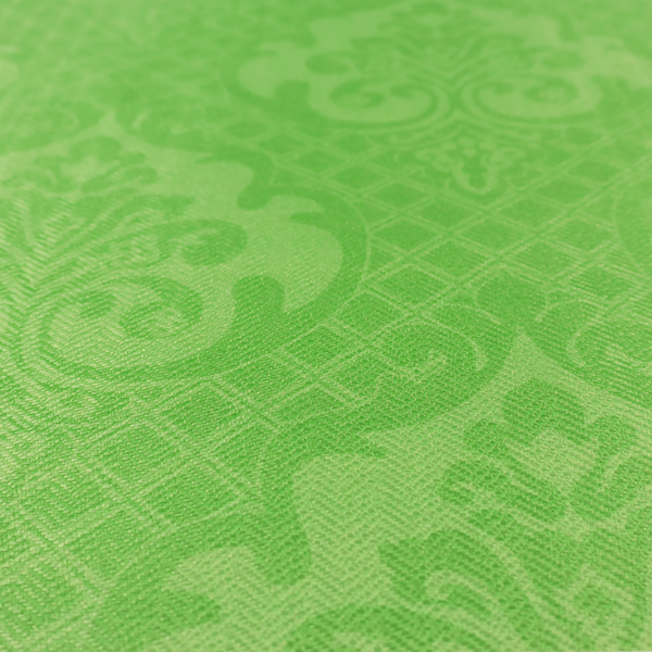 The design features large, ornate floral medallions and scrolling acanthus leaves in a vibrant lime shade, set against a slightly lighter green background. A fine diagonal lattice grid fills the background between the motifs, and the material shows a clear woven texture that provides visual depth to the tonal design.