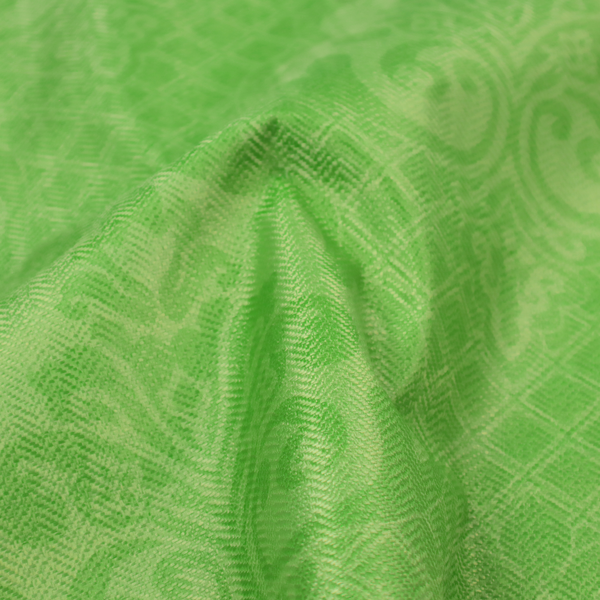 The design features large, ornate floral medallions and scrolling acanthus leaves in a vibrant lime shade, set against a slightly lighter green background. A fine diagonal lattice grid fills the background between the motifs, and the material shows a clear woven texture that provides visual depth to the tonal design.