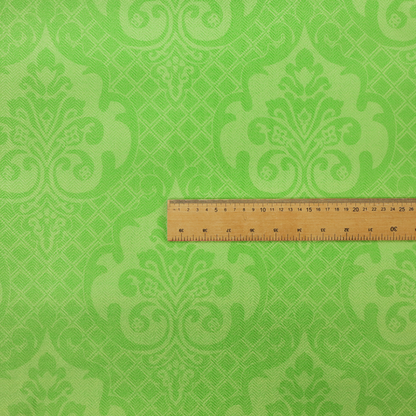 The design features large, ornate floral medallions and scrolling acanthus leaves in a vibrant lime shade, set against a slightly lighter green background. A fine diagonal lattice grid fills the background between the motifs, and the material shows a clear woven texture that provides visual depth to the tonal design.