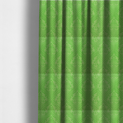The fabric used to create these made-to-measure curtains has a design that features large, ornate floral medallions and scrolling acanthus leaves in a vibrant lime shade, set against a slightly lighter green background. A fine diagonal lattice grid fills the background between the motifs, and the material shows a clear woven texture that provides visual depth to the tonal design.
