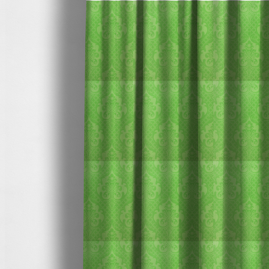 The fabric used to create these made-to-measure curtains has a design that features large, ornate floral medallions and scrolling acanthus leaves in a vibrant lime shade, set against a slightly lighter green background. A fine diagonal lattice grid fills the background between the motifs, and the material shows a clear woven texture that provides visual depth to the tonal design.
