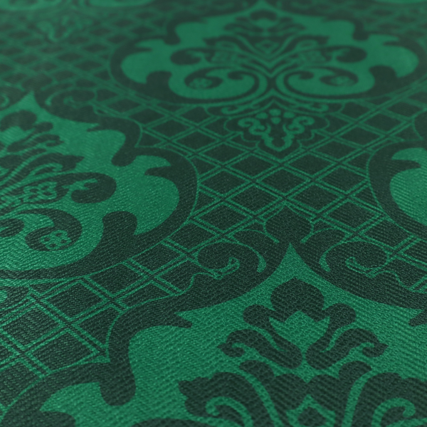 The design showcases large, ornate floral medallions and scrolling acanthus leaves in a vibrant green hue, set against a darker, forest green background. A fine diagonal lattice grid creates a diamond pattern in the spaces between the motifs, and the material displays a distinct woven texture that adds depth and classic character to the design.