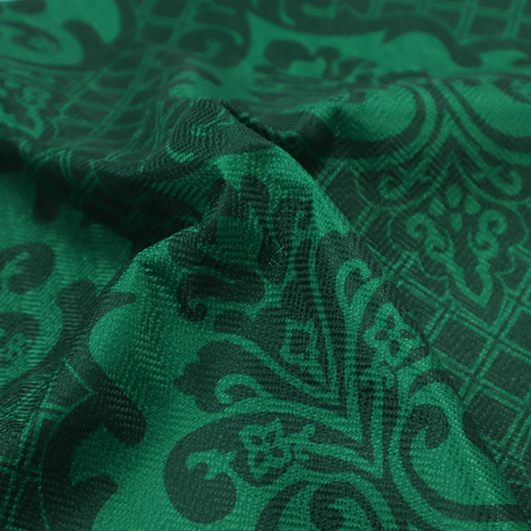 The design showcases large, ornate floral medallions and scrolling acanthus leaves in a vibrant green hue, set against a darker, forest green background. A fine diagonal lattice grid creates a diamond pattern in the spaces between the motifs, and the material displays a distinct woven texture that adds depth and classic character to the design.