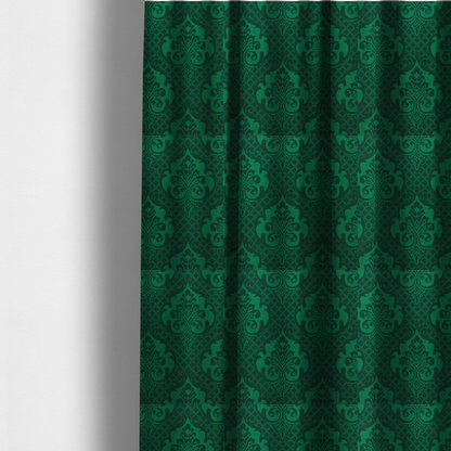 The fabric used to create these made-to-measure curtains has a design  that showcases large, ornate floral medallions and scrolling acanthus leaves in a vibrant green hue, set against a darker, forest green background. A fine diagonal lattice grid creates a diamond pattern in the spaces between the motifs, and the material displays a distinct woven texture that adds depth and classic character to the design.