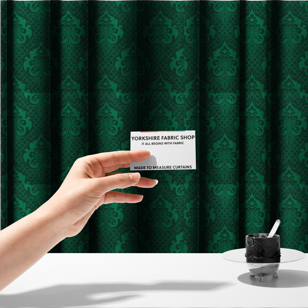 The fabric used to create these made-to-measure curtains has a design  that showcases large, ornate floral medallions and scrolling acanthus leaves in a vibrant green hue, set against a darker, forest green background. A fine diagonal lattice grid creates a diamond pattern in the spaces between the motifs, and the material displays a distinct woven texture that adds depth and classic character to the design.