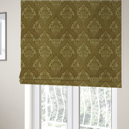 The fabric used to create these Roman blinds has a design that showcases large, ornate floral medallions and scrolling acanthus leaves in a muted tan shade, set against a rich ochre background. A fine diagonal lattice grid creates a diamond pattern in the spaces between the motifs, and the material displays a clear woven texture that adds depth and a subtle sheen to the pattern.