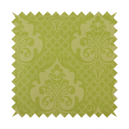 A lime green damask pattern on a textured fabric. The design features large, ornate floral medallions with stylized acanthus leaves, arranged in a repeating grid.