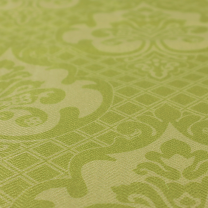 A lime green damask pattern on a textured fabric. The design features large, ornate floral medallions with stylized acanthus leaves, arranged in a repeating grid.